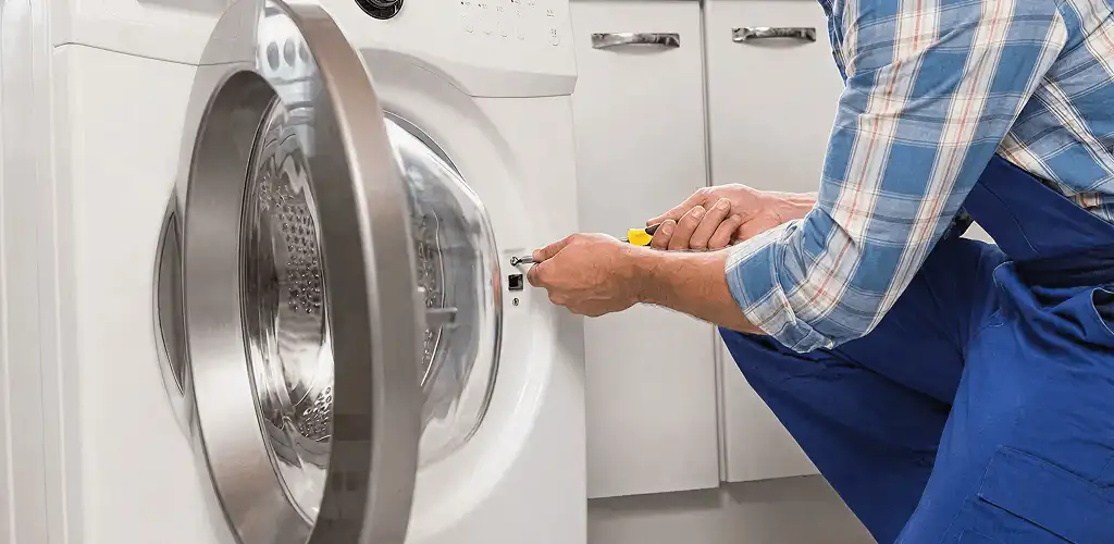 Handyman repairing a clothes dryer and checking electrical connections in Pasadena, CA