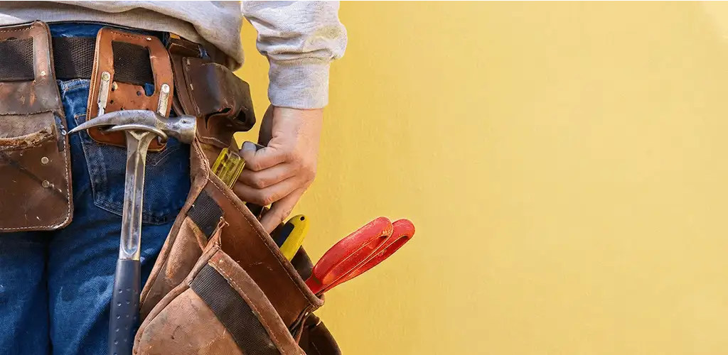 Handyman with tool belt ready for home repairs and maintenance in Pasadena, CA