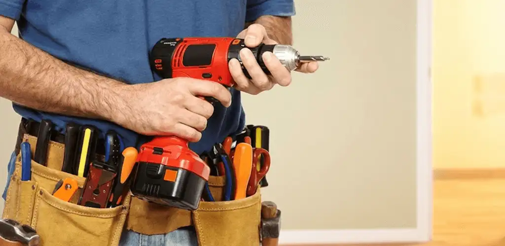 Handyman holding a power drill for home repairs and installations in Pasadena, CA